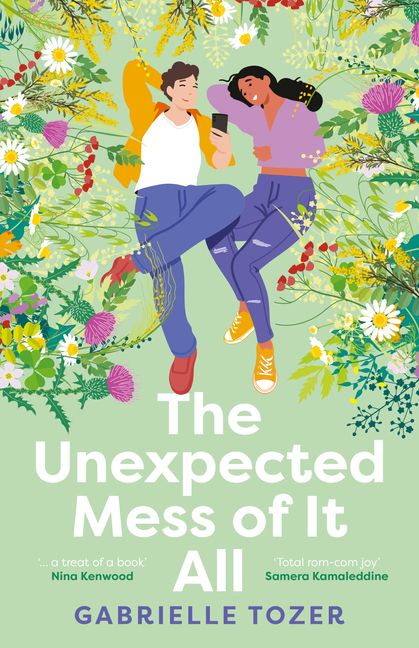 A pale green cover with flowers around the top half. A white boy with dark hair and in jeans and a t-shirt and jacket is next to a dark-skinned girl with black hair in jeans and a jumper. The boy is holding a phone. White text says The Unexpected Mess of It All and blue text reads Gabrielle Tozer. 